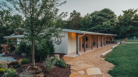 Stone walkway winding past the suites wing and gardens at Sommer House Inn